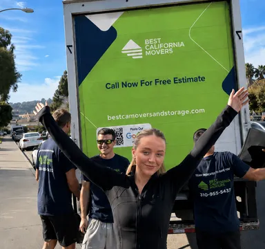 Best California Movers crew and a happy customer in front of the company truck