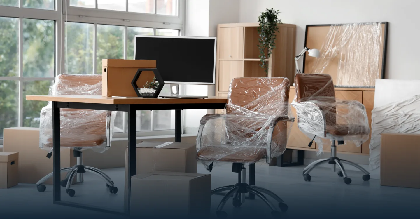 Office desks and chairs wrapped and boxed for a commercial move