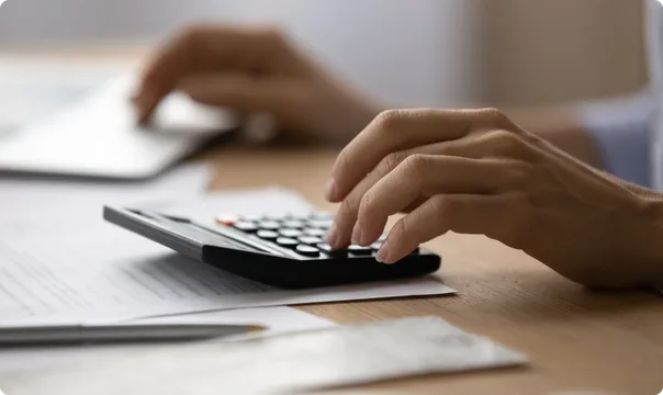 Hands working out moving costs on a calculator